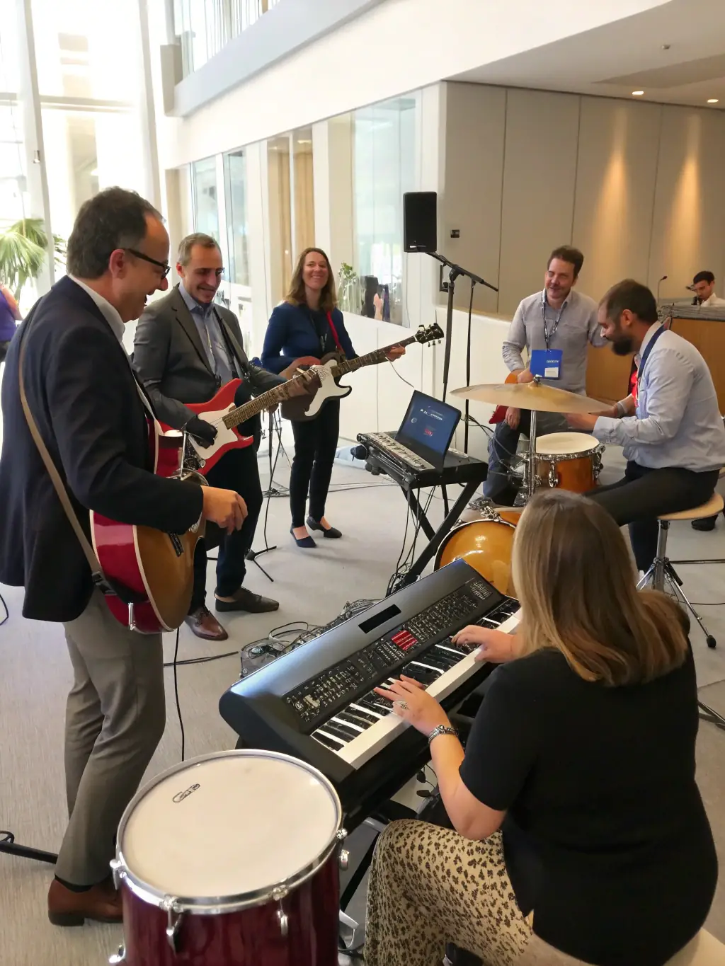 A photograph of a metal music workshop organized by LES VOIX DU CHAUDRON, showing participants actively engaged in learning about metal music techniques and history.