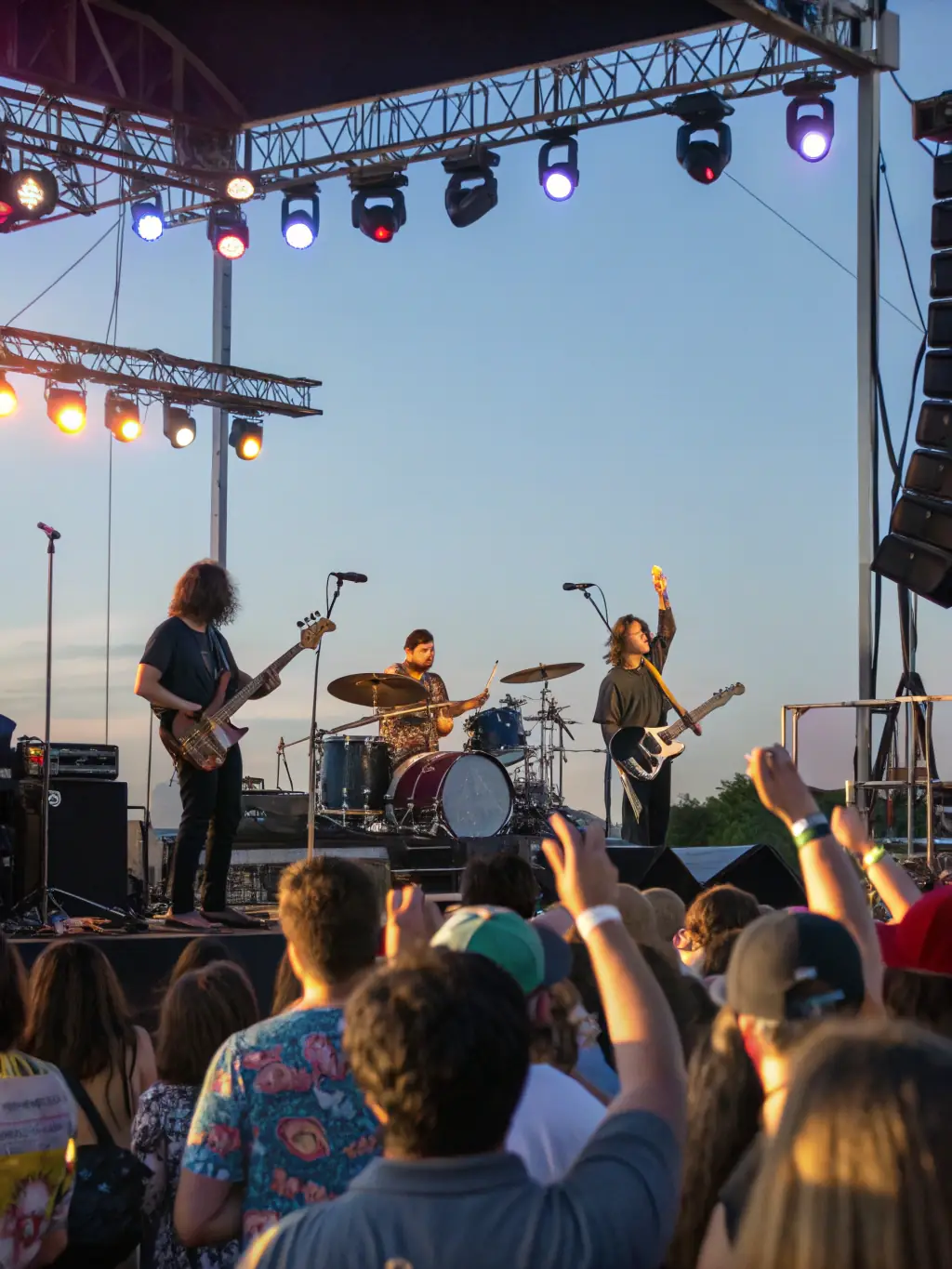 A dynamic shot of a rock band performing live at a community festival, capturing the excitement and engagement of the crowd.